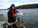 Graham Goulette (NOAA fisheries) deploys acoustic telemetry receiver in the Damariscott Estuary with a fish friend.