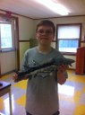 Ryan manages to keep this sturgeon from wiggling while his teacher took their picture!  Near the Kennebec, Maine.