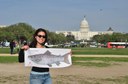 USFWS staff holding an Atlantic Salmon in front of the Capitol building.